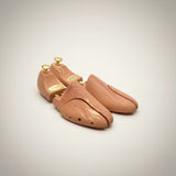 Wooden shoe trees on a light gray background