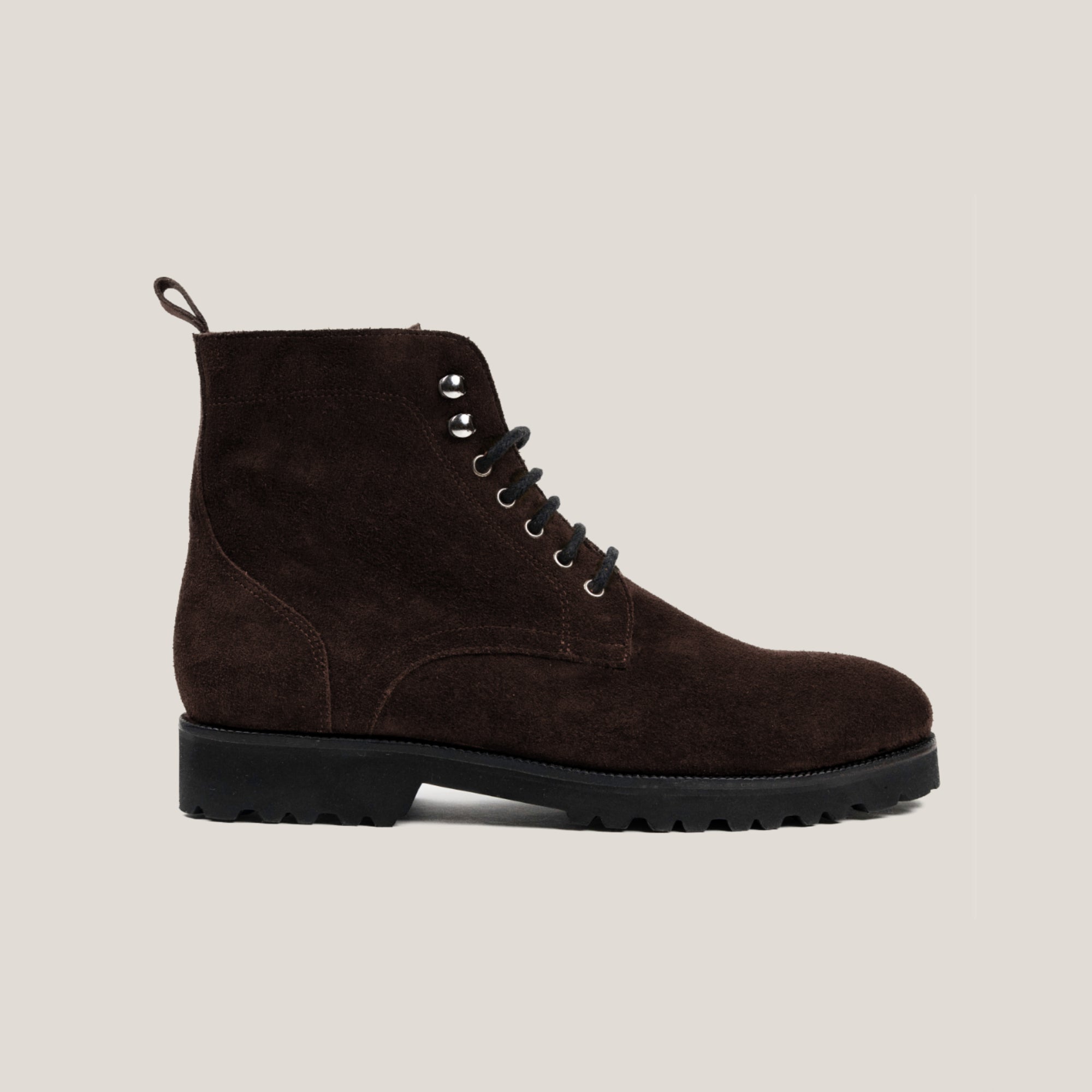 A dark brown suede lace-up boot with a round toe and a flat sole.