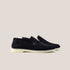 A pair of dark navy suede loafers with a white sole.