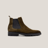 A camouflage green suede Chelsea boot with a black panel and a rubber sole.