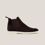 A dark brown suede Chelsea boot with a white sole.