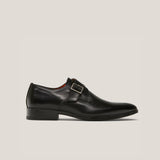 A black leather single monk strap shoe with a square buckle and a low heel.