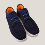 paired together view of a pair of navy suede laced design slip on sneakers with orange inner accents and a white sole