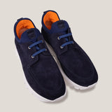 paired together view of a pair of navy suede laced design slip on sneakers with orange inner accents and a white sole